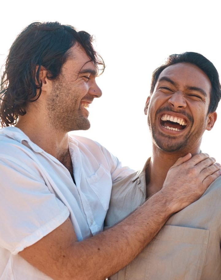 Love, laughing and gay couple on beach, hug and smile on summer vacation together in Thailand. Suns.